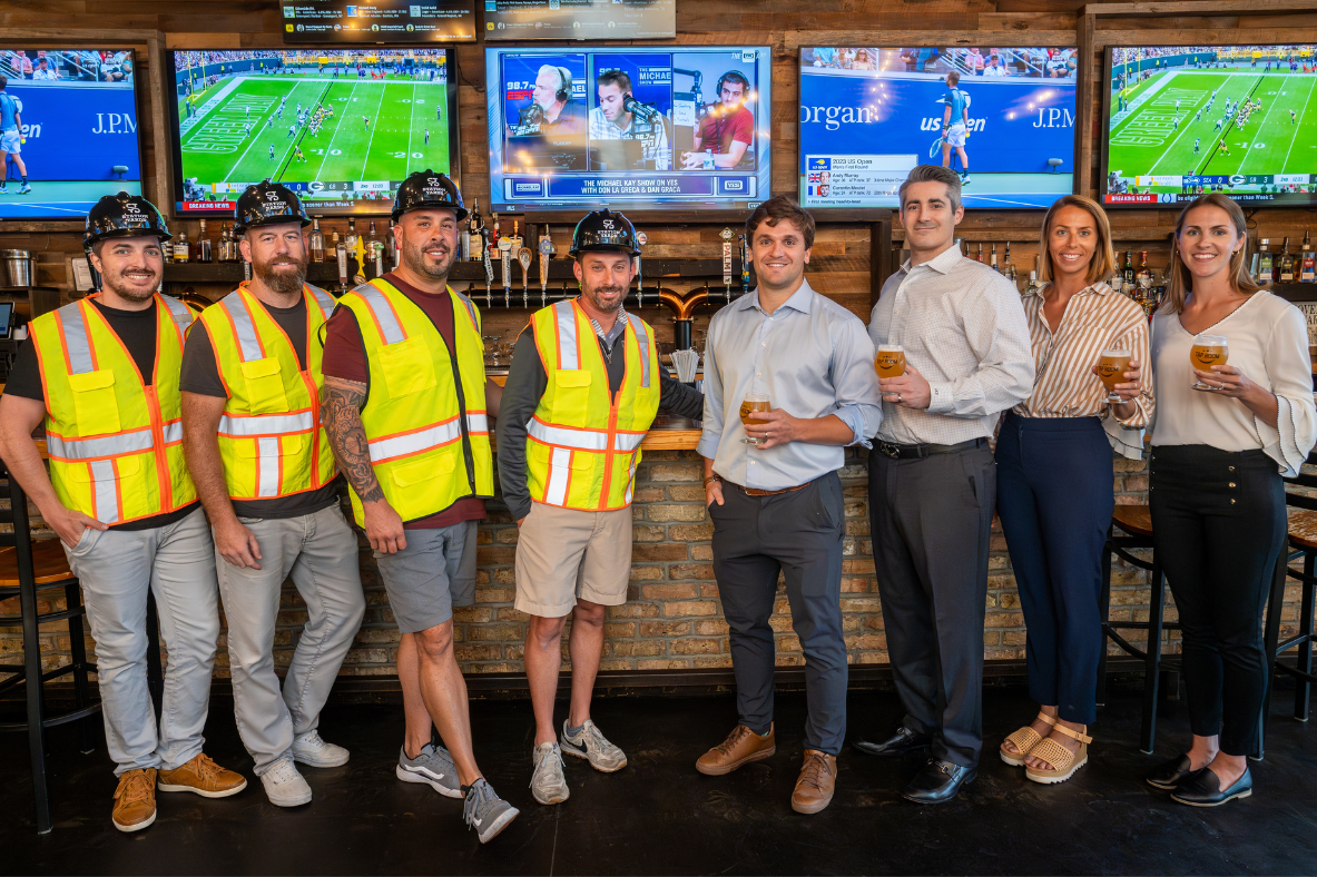 TRITEC Development team, Colliers, and the Tap Room celebrating the lease signing at Station Yards
