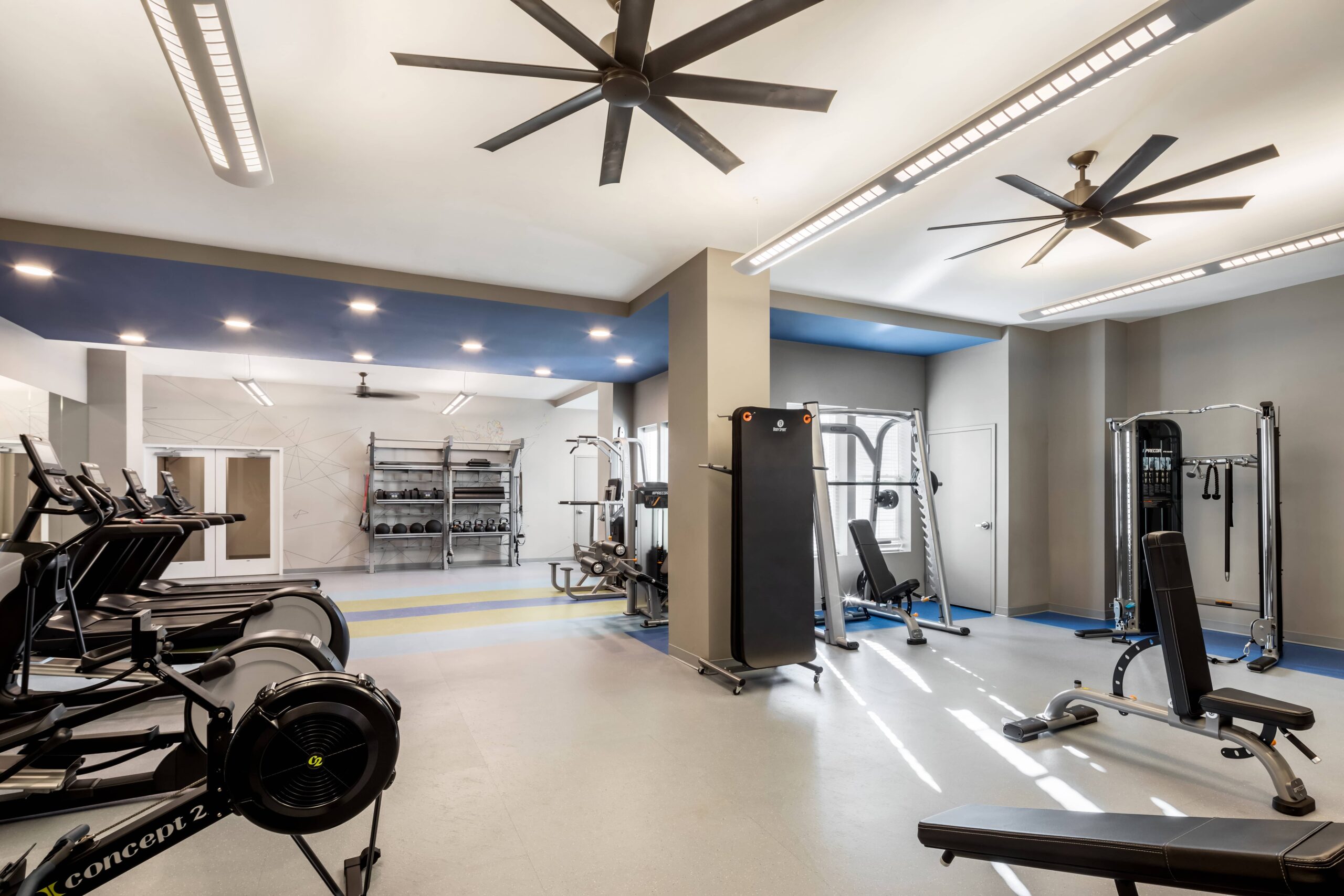 A fully equipped fitness center with weights and multiple machines.