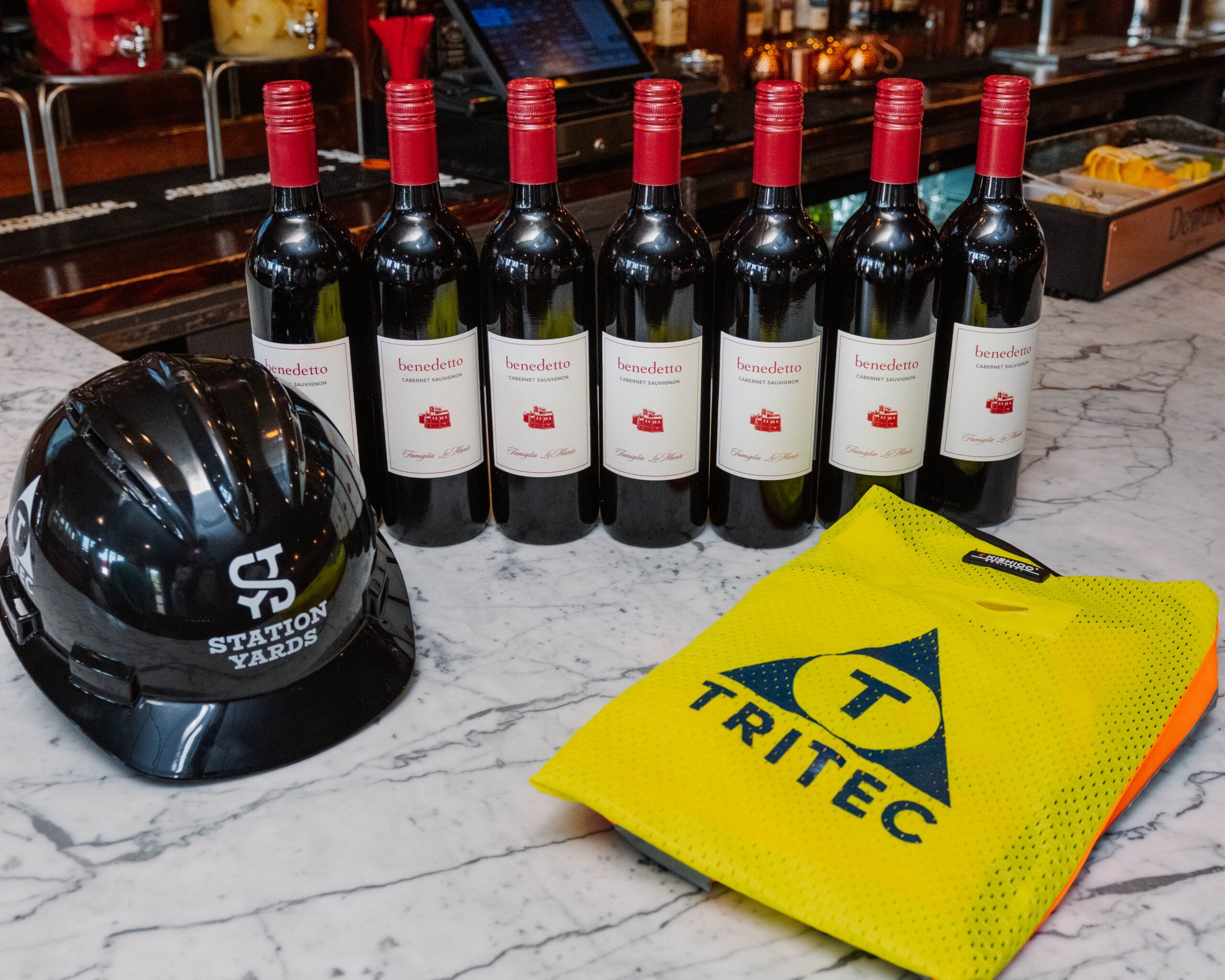 VESPA Italian Kitchen & Bar house wine with Station Yards hardhat and TRITEC safety vest