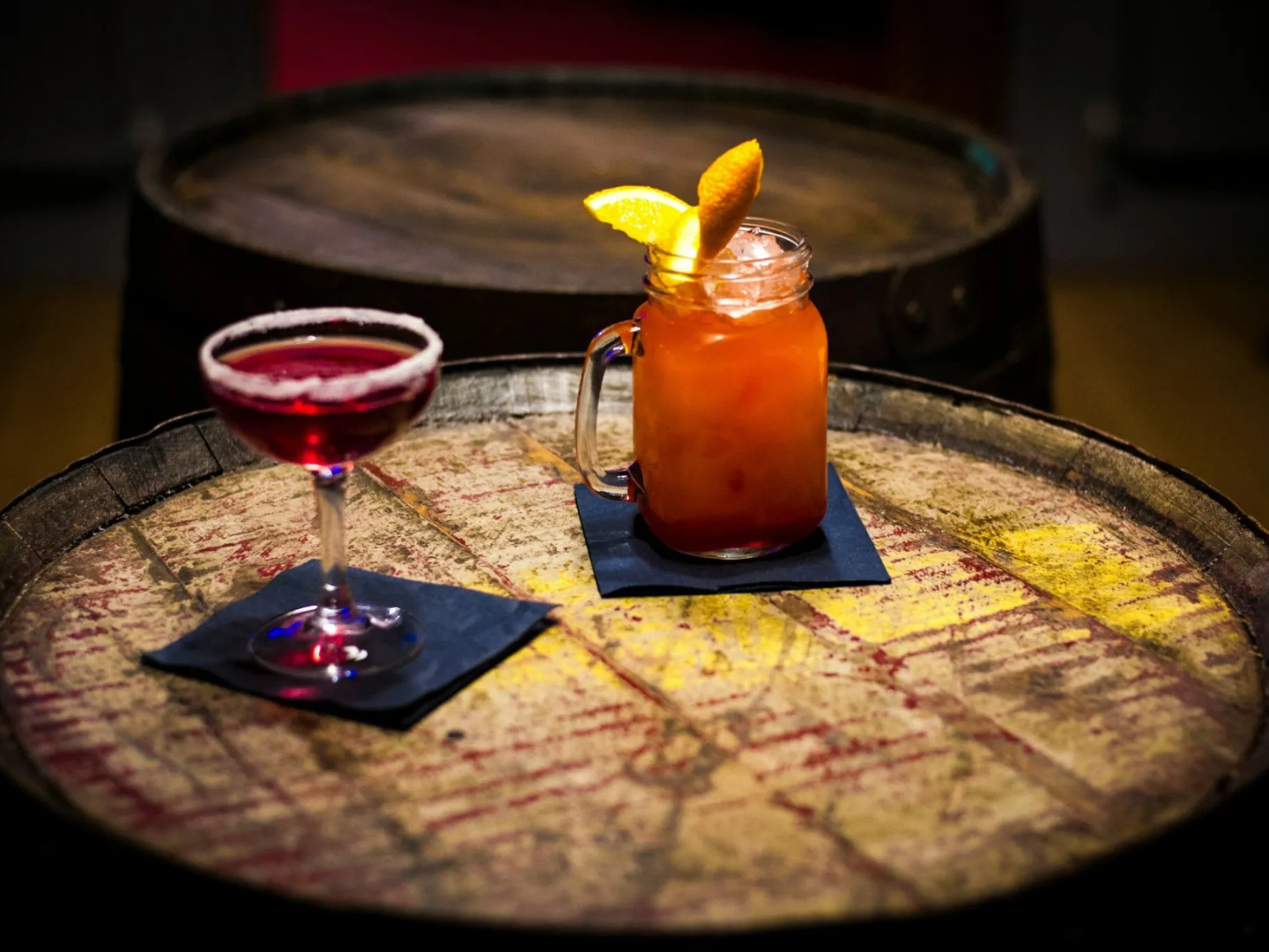 Two cocktails on a barrel at Artemis Speakeasy