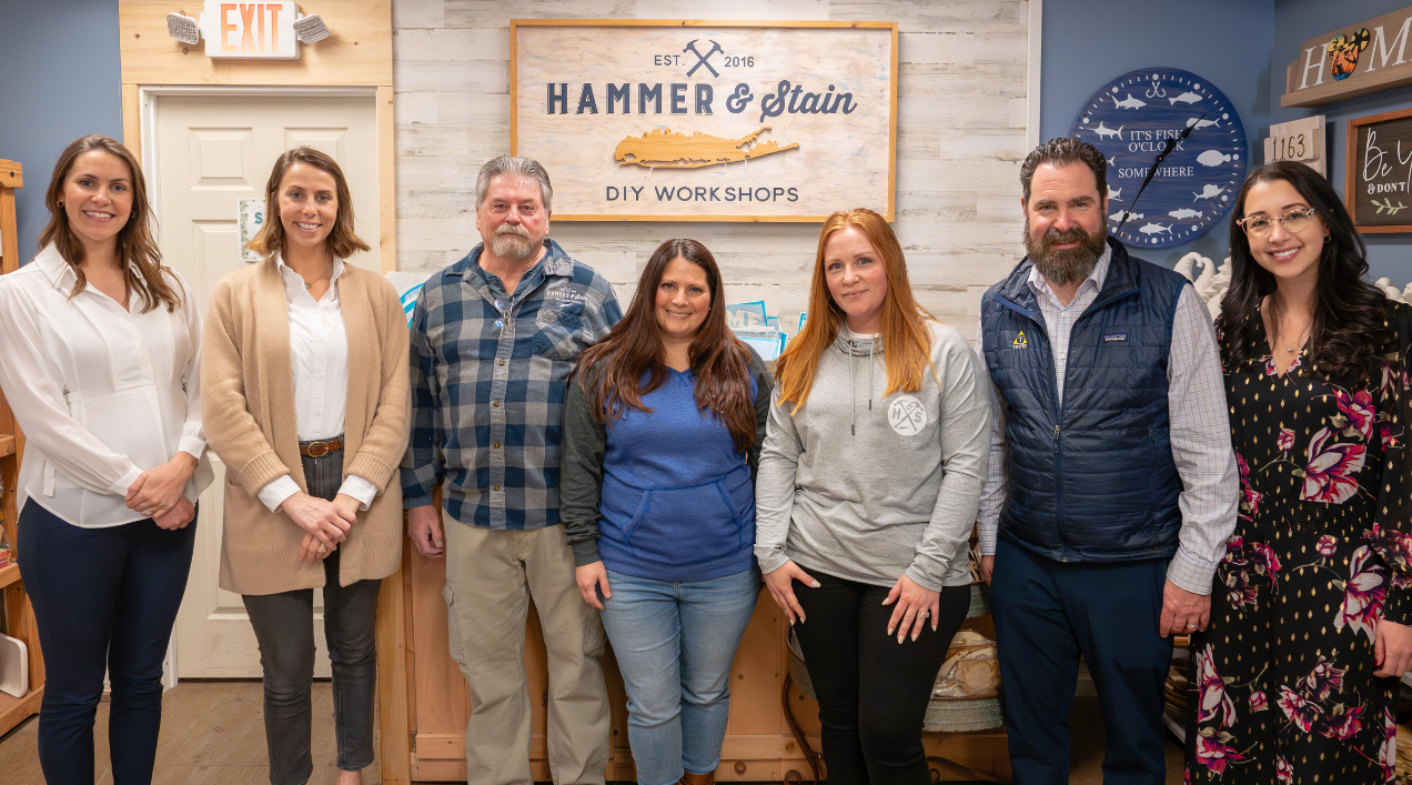 Meaghan Coughlan Treat, development manager at Tritec Real Estate, Kelley Heck, executive vice president at Tritec, Roy Winstanley, Hammer & Stain owner, Sandra Bernius, Hammer & Stain owner, Emily Mangano, operations manager at Hammer & Stain, Chris Kelly, senior vice president at Tritec, Jessica Nelson, Tritec senior marketing associate.