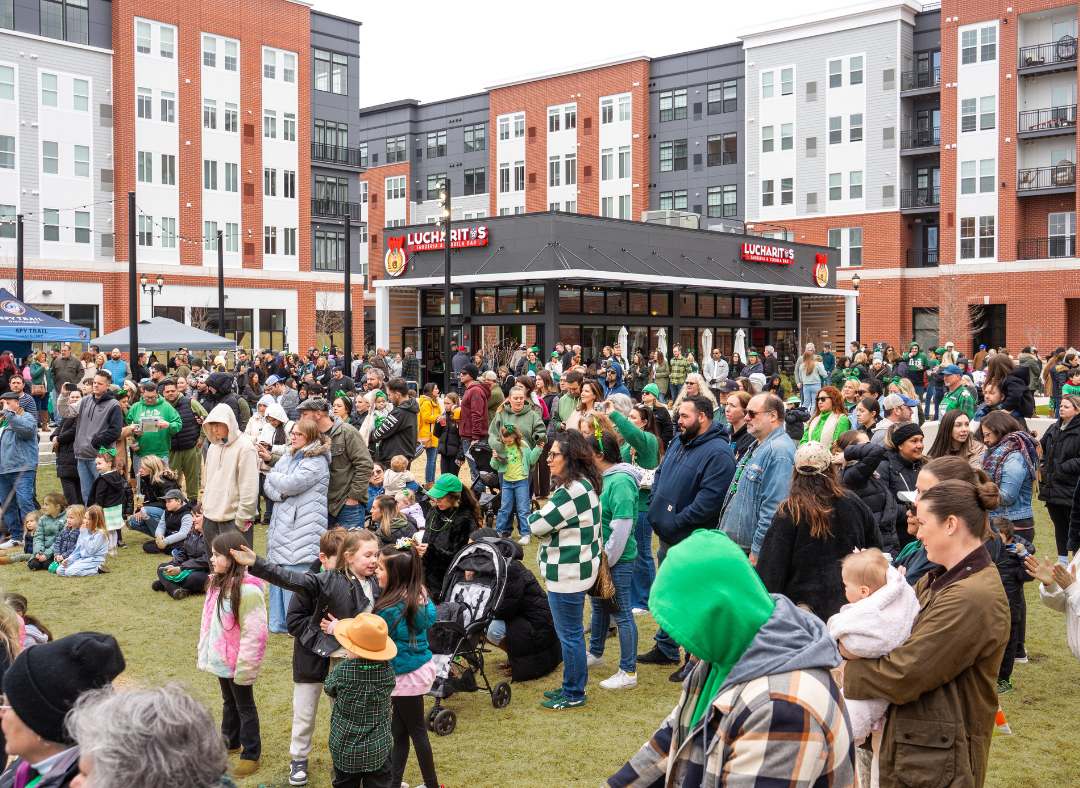 Large crowd of people on the Village Green during Station Paddy's Day