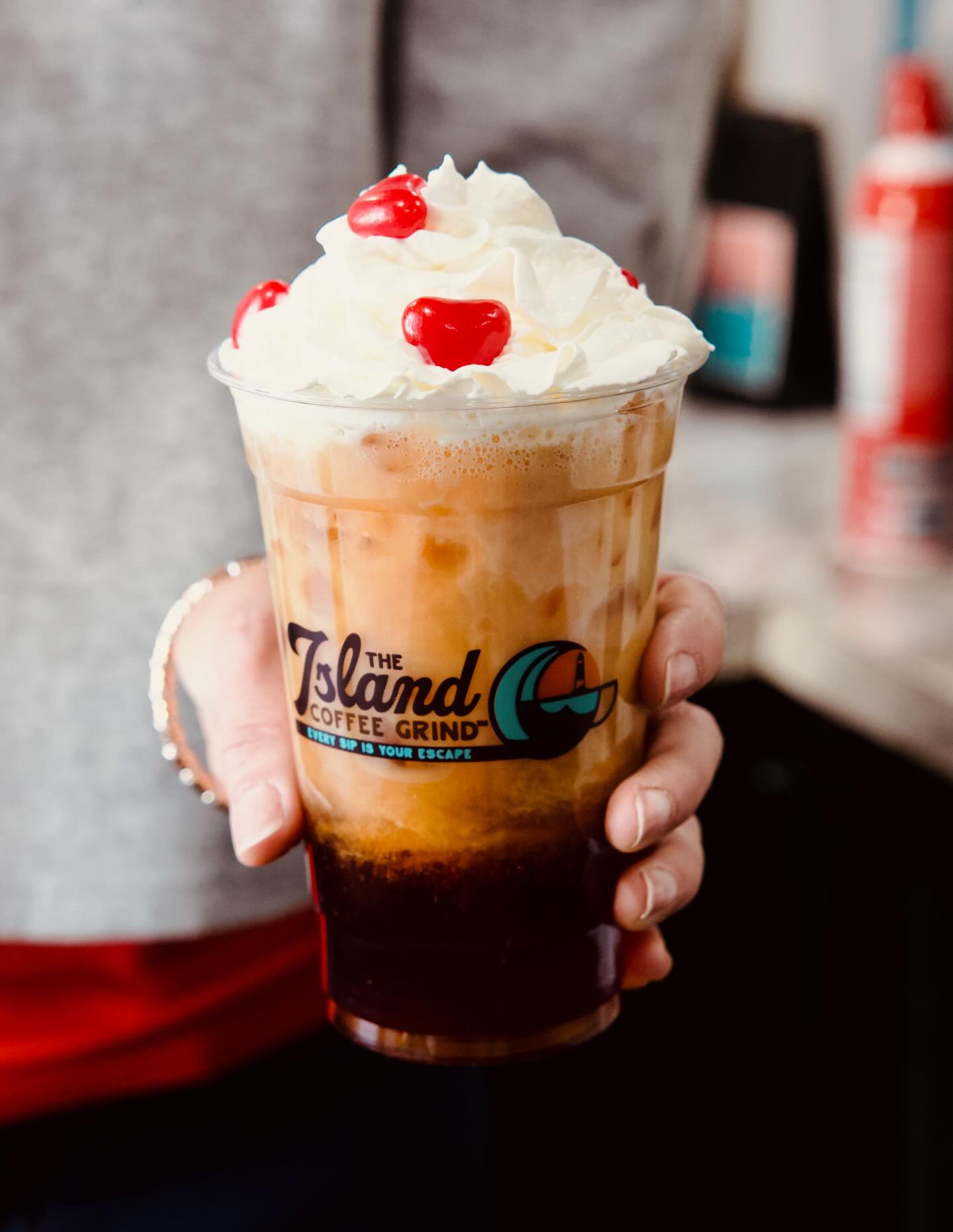 iced coffee from Island Coffee Grind with whipped cream and three maraschino cherries